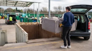 Resident taking sofa to recycling centre